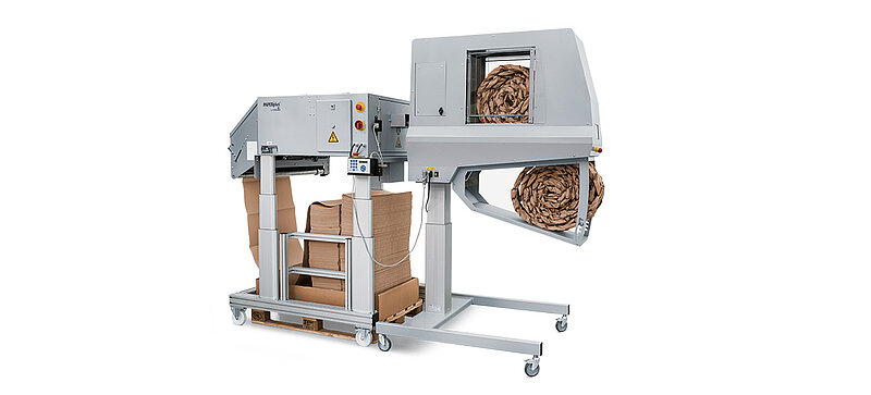 A gray machine making brown paper cushioning strips