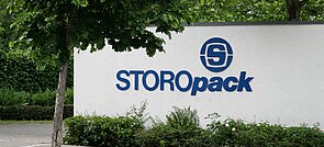 A white wall with blue Storopack logo